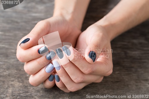 Image of Beautiful hands with the miniature painted in a gray-colored 