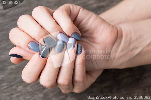 Image of Beautiful hands with the miniature painted in a gray-colored 