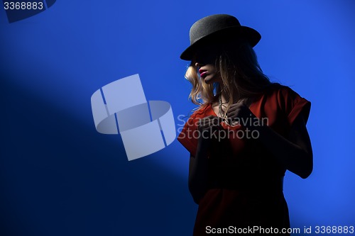 Image of Contrast portrait of sexy blonde in a red hat