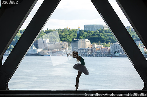 Image of Silhouette of graceful ballerina in white tutu