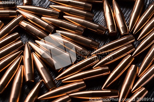 Image of Placer copper bullets on a dark wooden background