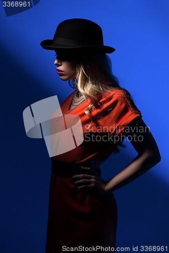 Image of Contrast portrait of sexy blonde in a red hat