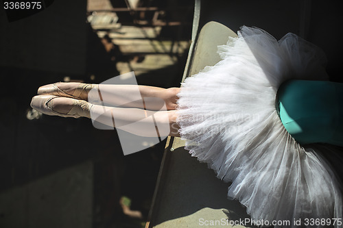 Image of Ballerina sitting on the edge of bridge