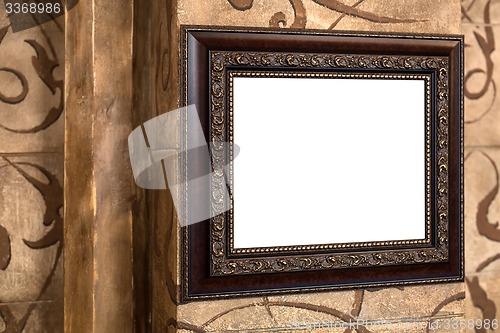 Image of Wooden old frame on the wall with empty content