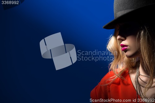 Image of Contrast portrait of sexy blonde in a red hat