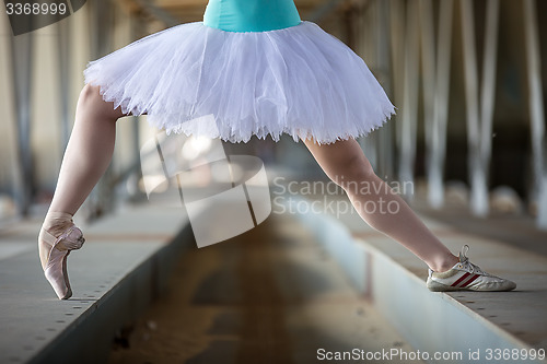 Image of Cropped picture legs of graceful ballerina in white tutu