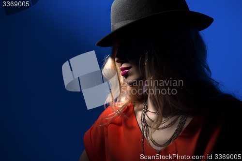 Image of Contrast portrait of sexy blonde in a red hat