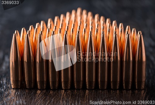 Image of Macro shot of copper bullets that are in many rows to form a tri