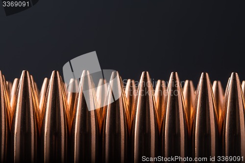 Image of Macro shot of copper bullets that are in many row