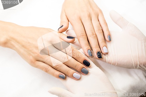 Image of Photo close-up of a beautiful stylish manicure with multicolored