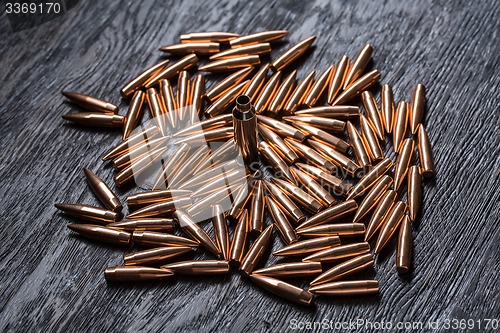 Image of Placer copper bullets on a dark wooden background