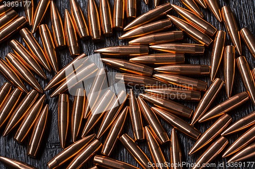 Image of Placer copper bullets on a dark wooden background