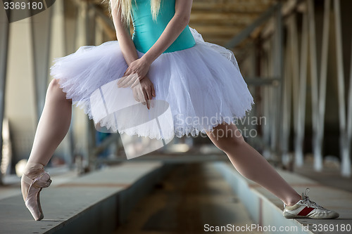 Image of Cropped picture legs of graceful ballerina in white tutu