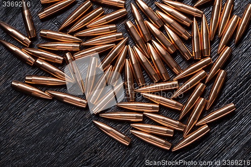 Image of Placer copper bullets on a dark wooden background
