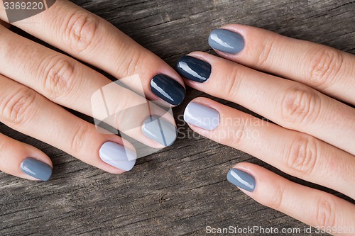 Image of Beautiful hands with the miniature painted in a gray-colored 