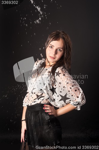 Image of Attractive woman in wet dress with falling water