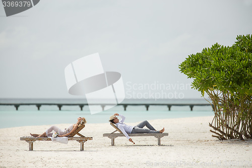 Image of couple on the sun loungers