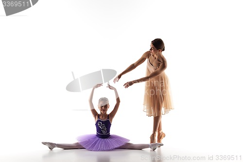 Image of The little ballerina dancing with personal ballet teacher in dance studio