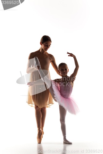 Image of The little ballerina dancing with personal ballet teacher in dance studio