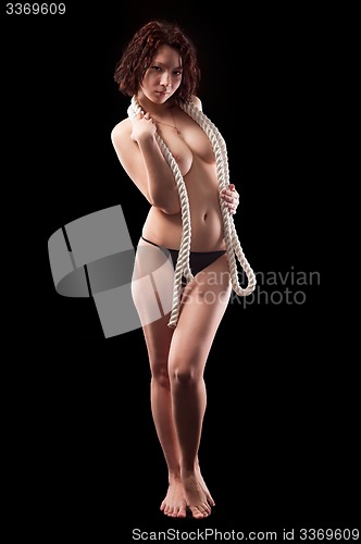 Image of Young topless woman body covering by rope