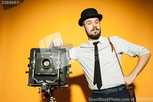 Image of young man with retro camera 