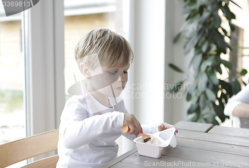Image of Boy eating yogurt