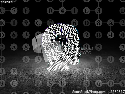 Image of Information concept: Head With Light Bulb in grunge dark room