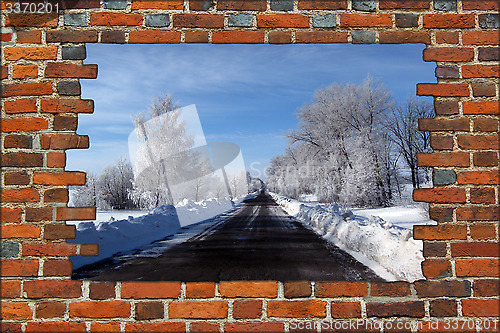 Image of broken brick wall and view to Winter highway