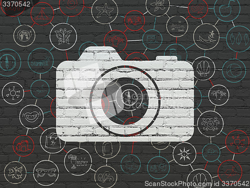 Image of Vacation concept: Photo Camera on wall background