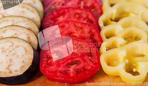 Image of In front sliced eggplant tomato and sweet pepper