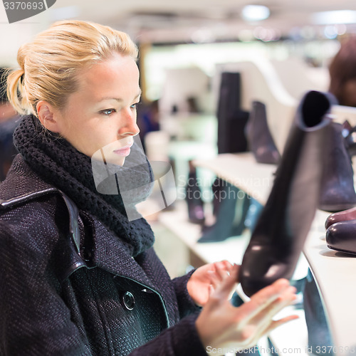 Image of Beautiful woman shopping in shoe store.