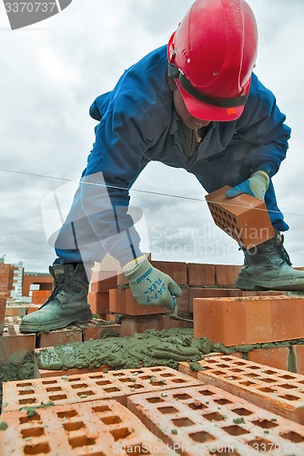 Image of Construction mason worker bricklayer under working