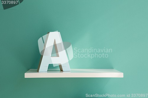 Image of Letter A on a white shelf.