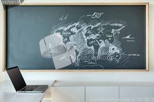 Image of Painted white chalk map of the world in a humorous style