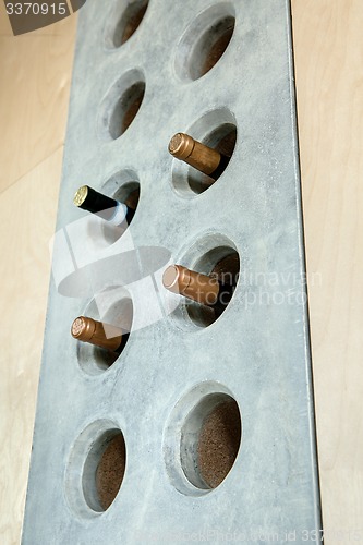 Image of Several bottles of wine in a special concrete hole