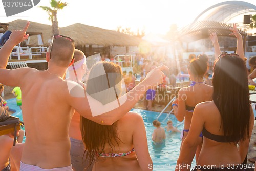 Image of Youth dancing on a beach party.