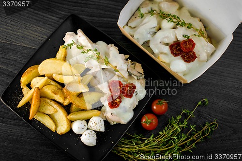 Image of Delicious portion of rustic potatoes fillet with aromatic herbs