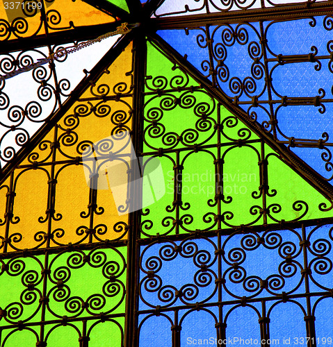 Image of colorated glass and sun in morocco africa window and light