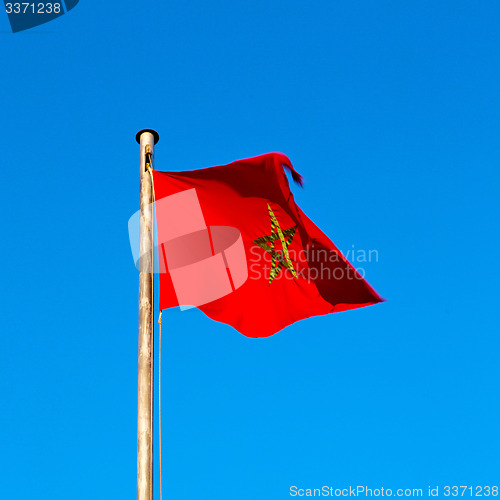 Image of tunisia  waving flag in the blue sky  colour and battlements  wa