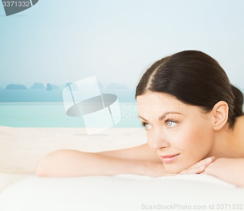 Image of happy beautiful woman lying in spa