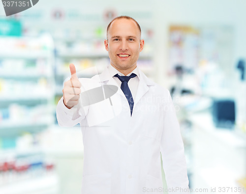 Image of smiling pharmacist showing thumbs up at drugstore