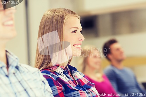 Image of group of smiling students in lecture hall