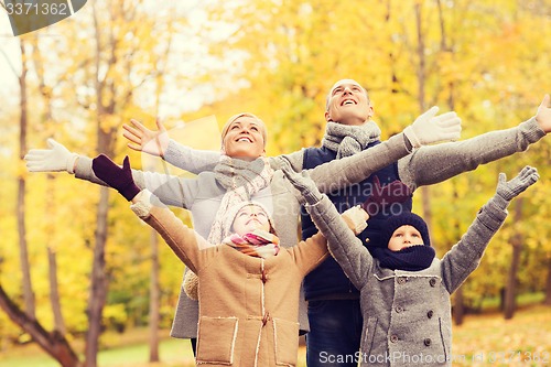 Image of happy family having fun in autumn park