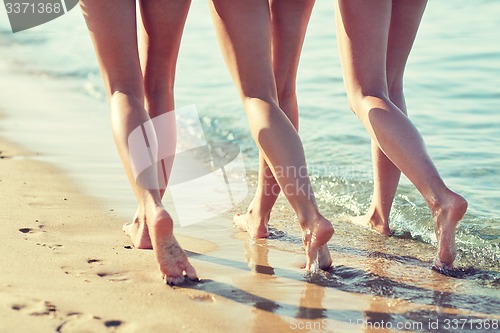 Image of close up of happy young women on beach