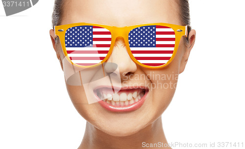 Image of angry teenage girl in glasses with american flag