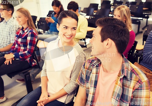 Image of group of smiling students in lecture hall