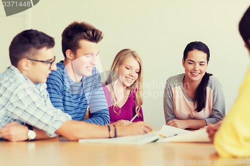 Image of group of smiling students with blueprint