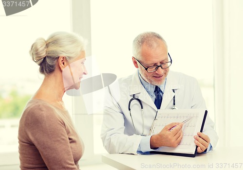 Image of smiling senior woman and doctor meeting