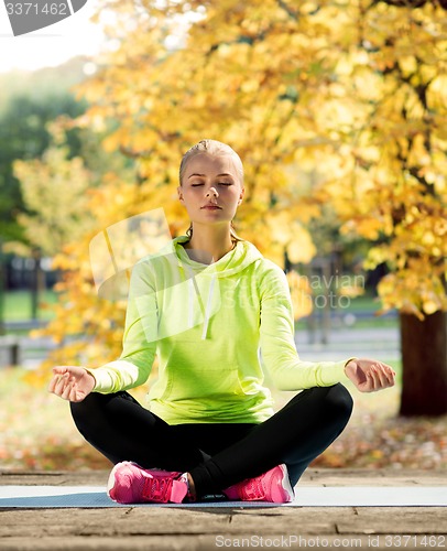 Image of woman doing yoga outdoors