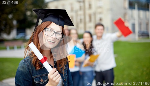 Image of group of smiling students with diploma and folders